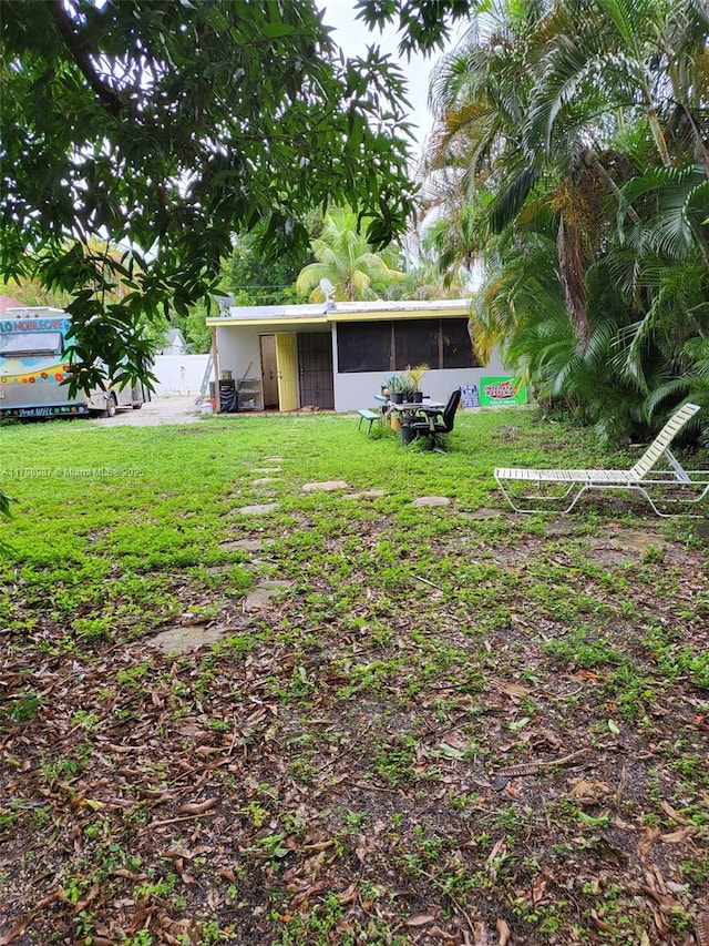 2415 Garfield St, Hollywood, FL 33020 - view of grassy yard featuring a sunroom