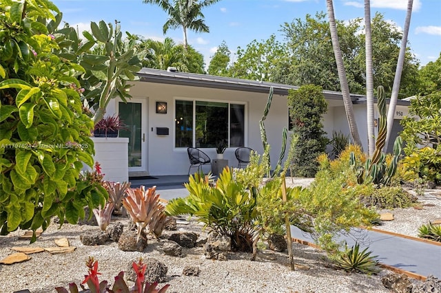950 NE 88th St, Miami, FL 33138 - entrance to property with stucco siding and a porch