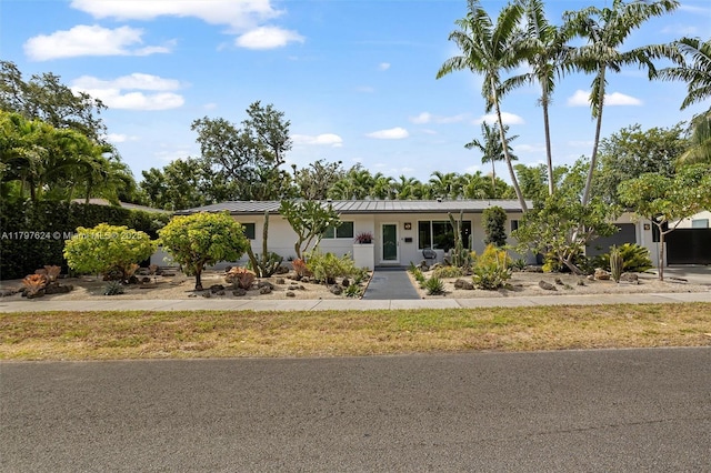 950 NE 88th St, Miami, FL 33138 - single story home featuring metal roof, stucco siding, and a standing seam roof