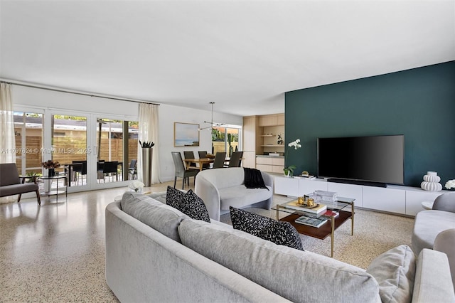 950 NE 88th St, Miami, FL 33138 - living room featuring speckled floor, built in shelves, and french doors