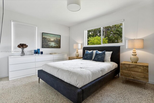 950 NE 88th St, Miami, FL 33138 - bedroom featuring dark aggregate flooring and baseboards