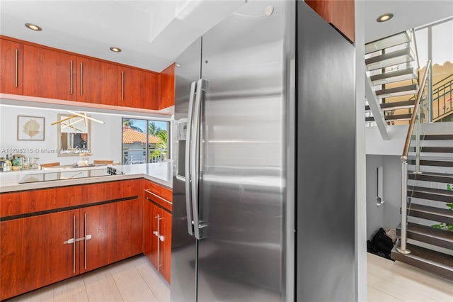 140 Jefferson Ave Unit 14020, Miami Beach, FL 33139 - kitchen with stainless steel fridge, light countertops, recessed lighting, and brown cabinets