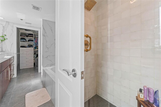 140 Jefferson Ave Unit 14020, Miami Beach, FL 33139 - full bathroom with a tile shower, a spacious closet, vanity, and tile walls