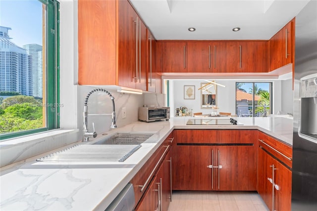 140 Jefferson Ave Unit 14020, Miami Beach, FL 33139 - kitchen with plenty of natural light, light stone countertops, black electric stovetop, and recessed lighting