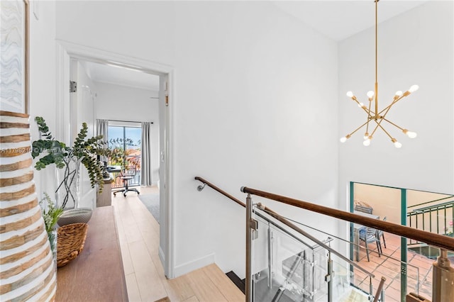 140 Jefferson Ave Unit 14020, Miami Beach, FL 33139 - hall with a chandelier, an upstairs landing, and wood finished floors