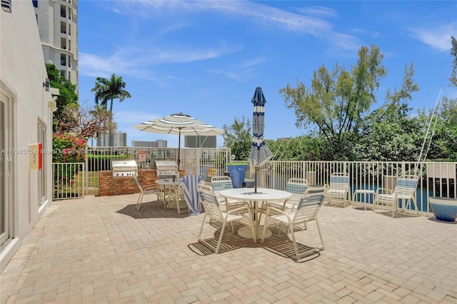 2840 NE 14th St Cswy Unit 408A, Pompano Beach, FL 33062 - view of patio / terrace featuring area for grilling, outdoor dining space, a grill, and fence