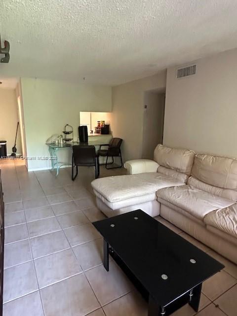 1900 N Congress Ave Unit 305, West Palm Beach, FL 33401 - living room with a textured ceiling and tile patterned floors