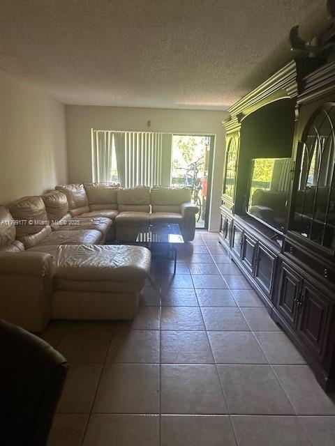 1900 N Congress Ave Unit 305, West Palm Beach, FL 33401 - living room with tile patterned floors and a textured ceiling