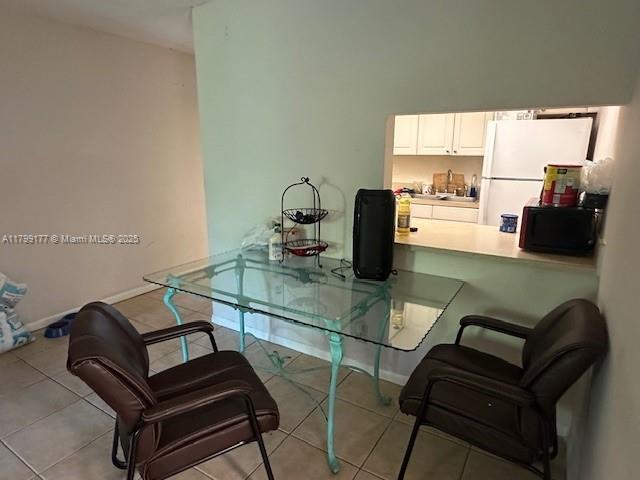 1900 N Congress Ave Unit 305, West Palm Beach, FL 33401 - dining room featuring baseboards and tile patterned flooring