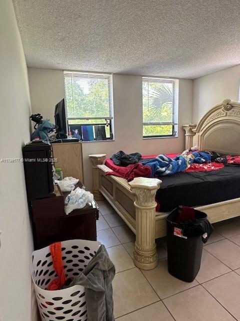 1900 N Congress Ave Unit 305, West Palm Beach, FL 33401 - bedroom featuring light tile patterned flooring and a textured ceiling