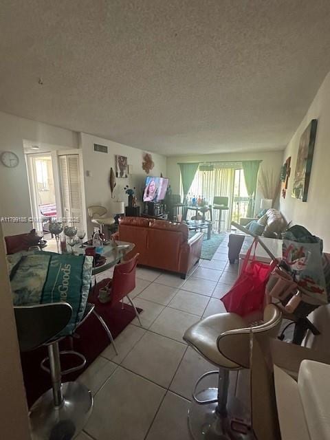 1820 N Congress Ave Unit 405, West Palm Beach, FL 33401 - living room featuring light tile patterned floors and a textured ceiling