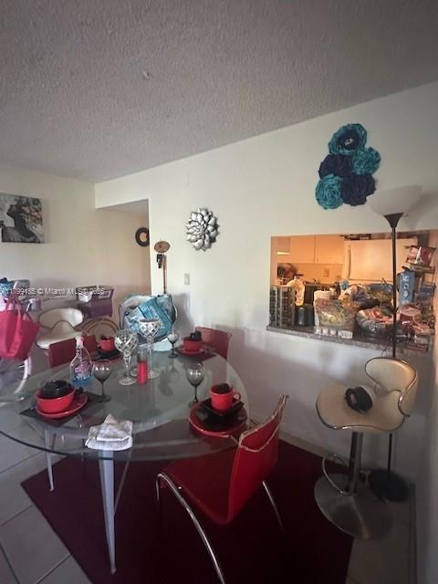 1820 N Congress Ave Unit 405, West Palm Beach, FL 33401 - dining space with a textured ceiling