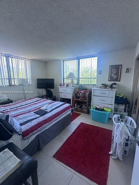 1820 N Congress Ave Unit 405, West Palm Beach, FL 33401 - tiled bedroom featuring a textured ceiling