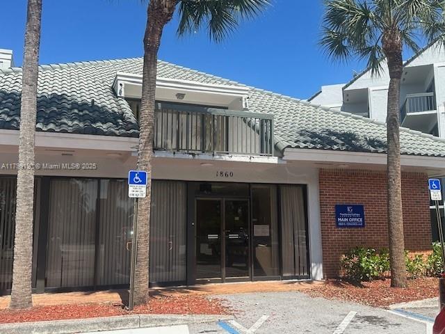 2000 N Congress Ave Unit 411, West Palm Beach, FL 33401 - view of building exterior featuring uncovered parking