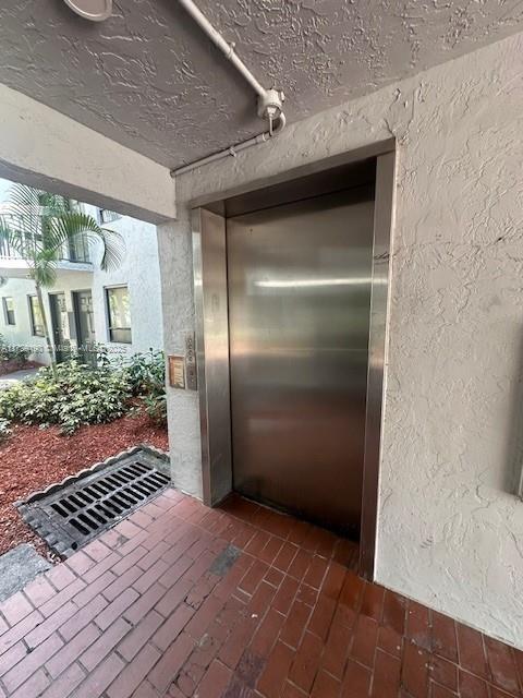 2000 N Congress Ave Unit 411, West Palm Beach, FL 33401 - property entrance with elevator and stucco siding