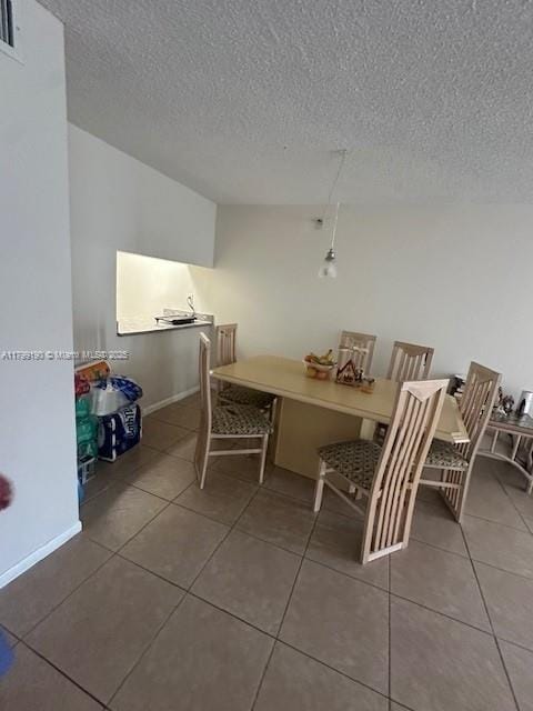 2000 N Congress Ave Unit 411, West Palm Beach, FL 33401 - tiled dining area featuring a textured ceiling