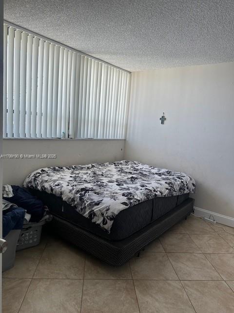 2000 N Congress Ave Unit 411, West Palm Beach, FL 33401 - tiled bedroom with a textured ceiling