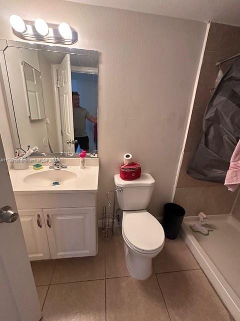 2000 N Congress Ave Unit 411, West Palm Beach, FL 33401 - bathroom with tile patterned floors, a shower stall, vanity, and toilet