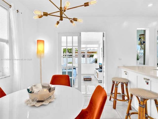 729 85th St, Miami Beach, FL 33141 - dining area featuring light tile patterned floors and a chandelier