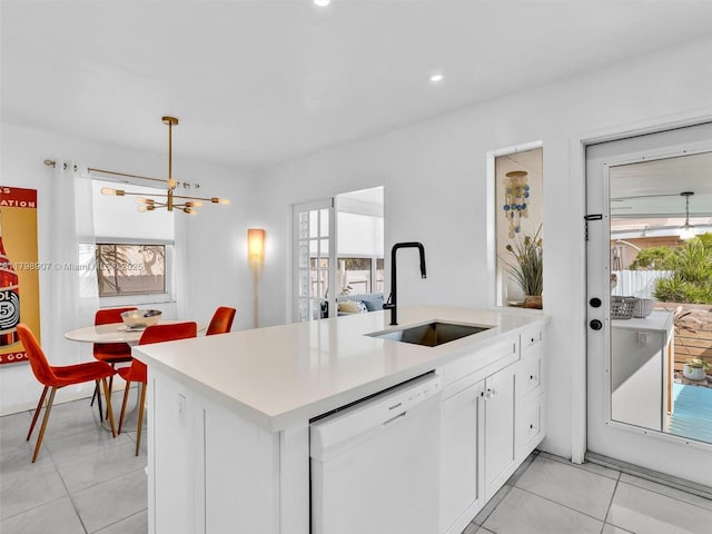 729 85th St, Miami Beach, FL 33141 - kitchen featuring a sink, dishwasher, light countertops, a chandelier, and white cabinetry