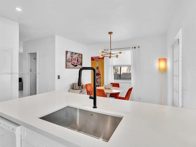 729 85th St, Miami Beach, FL 33141 - kitchen featuring a sink, a chandelier, light countertops, dishwasher, and white cabinets