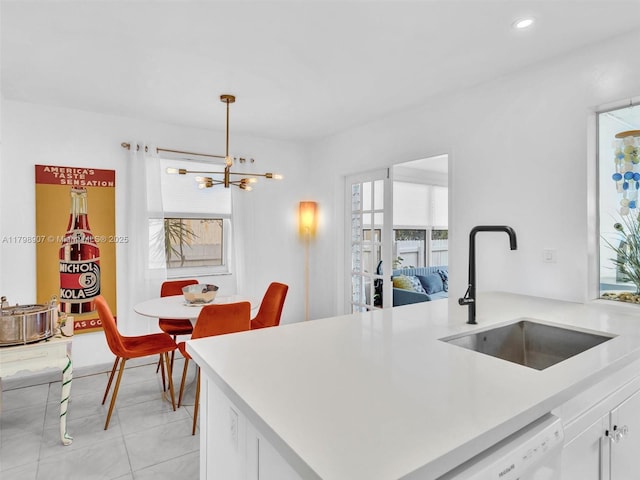 729 85th St, Miami Beach, FL 33141 - kitchen featuring a sink, a chandelier, light countertops, white cabinets, and recessed lighting