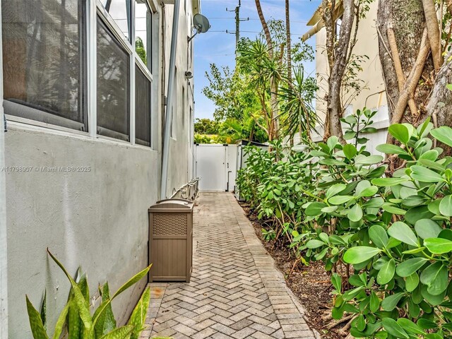 729 85th St, Miami Beach, FL 33141 - view of side of property featuring stucco siding and fence