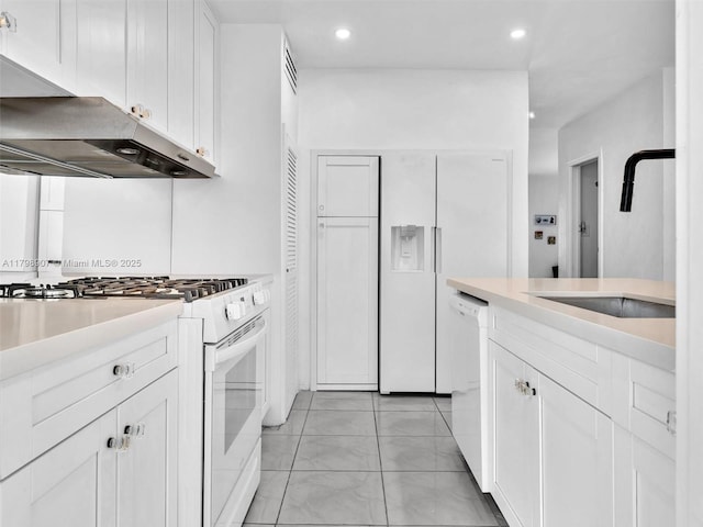 729 85th St, Miami Beach, FL 33141 - kitchen with white appliances, ventilation hood, a sink, white cabinets, and light countertops