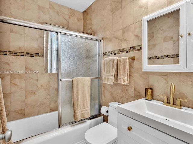 729 85th St, Miami Beach, FL 33141 - bathroom featuring tile walls, combined bath / shower with glass door, toilet, and vanity