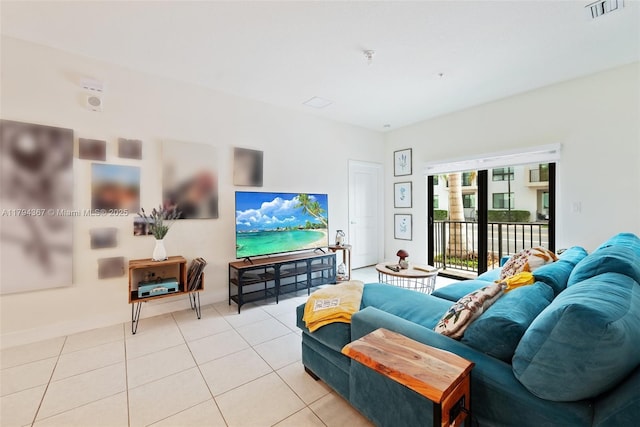 living area with light tile patterned floors and baseboards