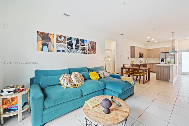 living area with light tile patterned floors and recessed lighting
