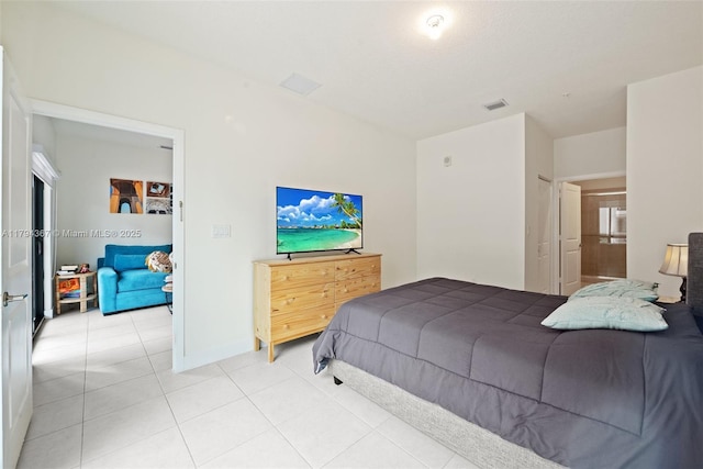 bedroom featuring light tile patterned floors and baseboards