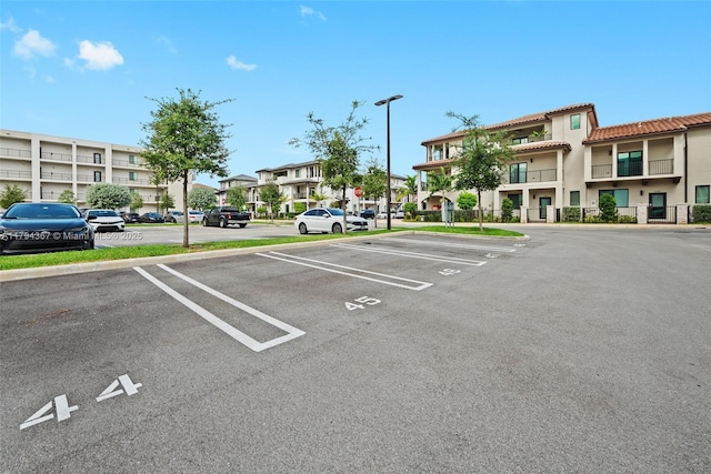 uncovered parking lot with a residential view