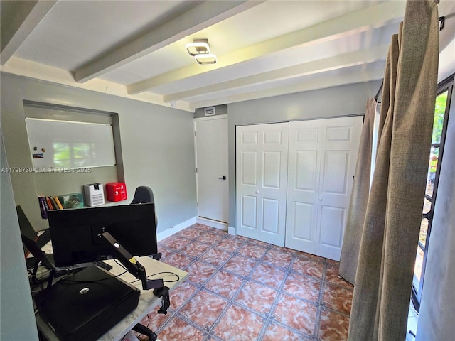 home office featuring beamed ceiling, tile patterned floors, and baseboards