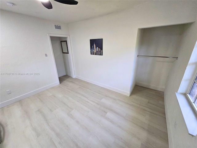 unfurnished bedroom featuring wood finished floors, baseboards, and a ceiling fan
