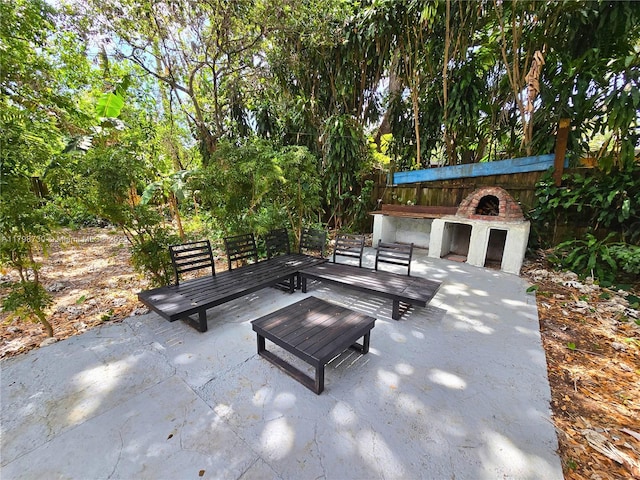 view of patio featuring an outdoor living space with a fireplace