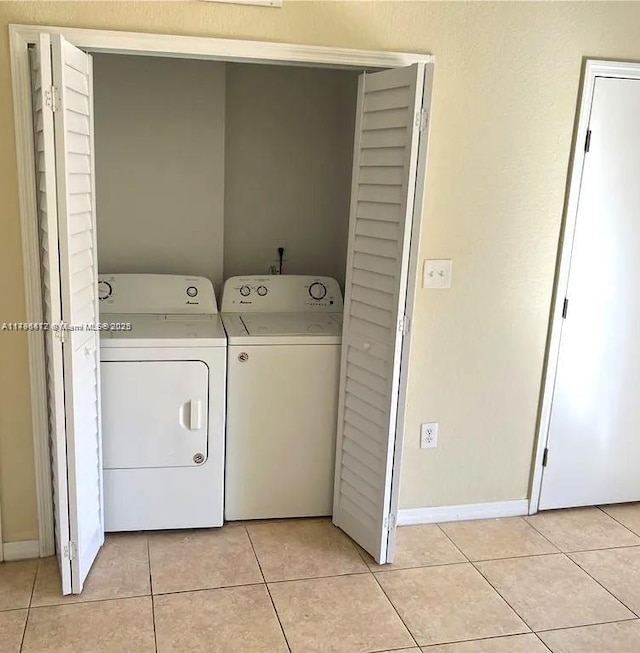 20441 NW 15th Ave Unit 8, Miami Gardens, FL 33169 - clothes washing area featuring washing machine and clothes dryer, light tile patterned floors, and baseboards