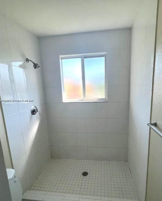 20441 NW 15th Ave Unit 8, Miami Gardens, FL 33169 - bathroom featuring a stall shower and toilet
