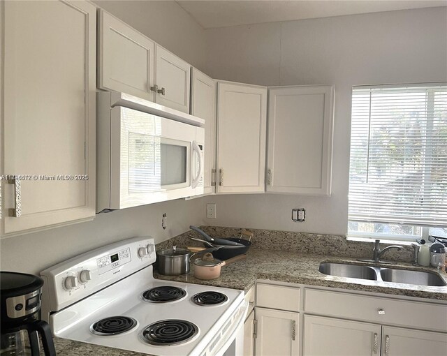 20441 NW 15th Ave Unit 8, Miami Gardens, FL 33169 - kitchen featuring white appliances, a sink, white cabinets, and light stone counters