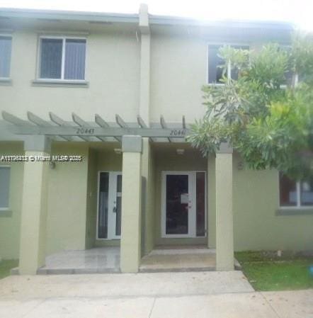 20441 NW 15th Ave Unit 8, Miami Gardens, FL 33169 - entrance to property featuring stucco siding and a pergola