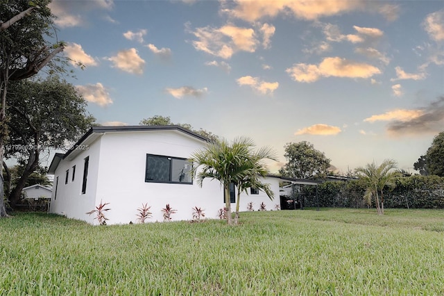 17940 NW 13th Ct, Miami Gardens, FL 33169 - view of side of property with stucco siding and a yard