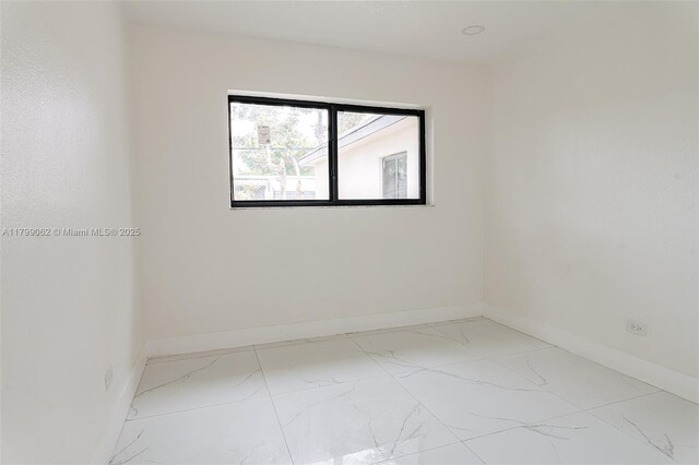 17940 NW 13th Ct, Miami Gardens, FL 33169 - empty room featuring marble finish flooring and baseboards