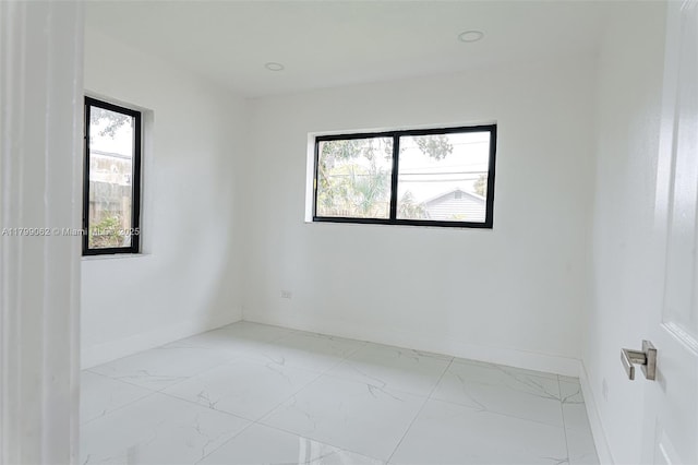 17940 NW 13th Ct, Miami Gardens, FL 33169 - spare room with plenty of natural light, light marble finish floors, and baseboards