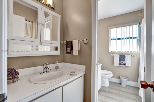 1930 W Oak Knoll Cir, Davie, FL 33324 - bathroom featuring toilet, vanity, wood finished floors, and baseboards