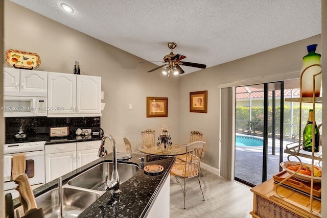 1930 W Oak Knoll Cir, Davie, FL 33324 - kitchen featuring white appliances, white cabinets, a textured ceiling, ceiling fan, and light wood-style floors