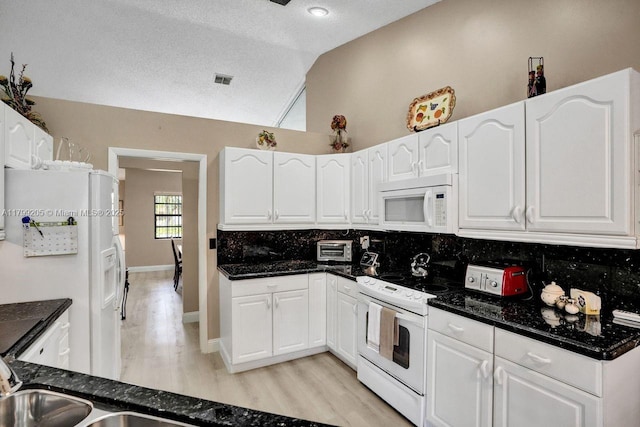 1930 W Oak Knoll Cir, Davie, FL 33324 - kitchen featuring white appliances, vaulted ceiling, decorative backsplash, light wood-style floors, and white cabinets