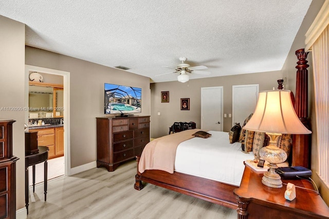 1930 W Oak Knoll Cir, Davie, FL 33324 - bedroom with light wood-style flooring, a textured ceiling, baseboards, connected bathroom, and ceiling fan