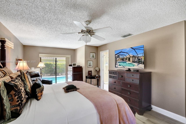 1930 W Oak Knoll Cir, Davie, FL 33324 - bedroom featuring access to exterior, a textured ceiling, wood finished floors, baseboards, and a ceiling fan