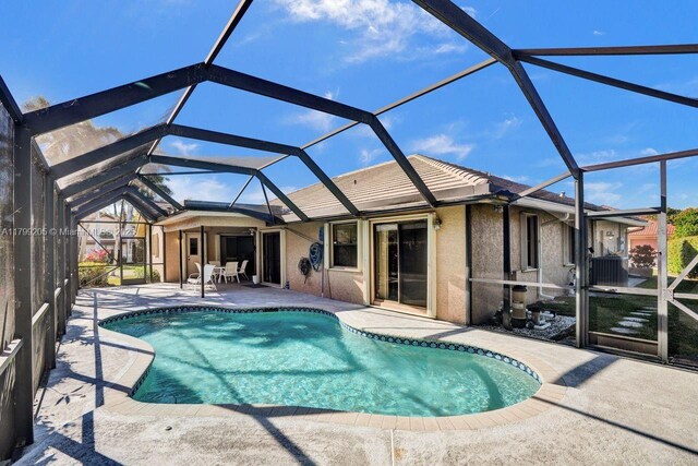 1930 W Oak Knoll Cir, Davie, FL 33324 - swimming pool with a patio area, glass enclosure, and central AC unit