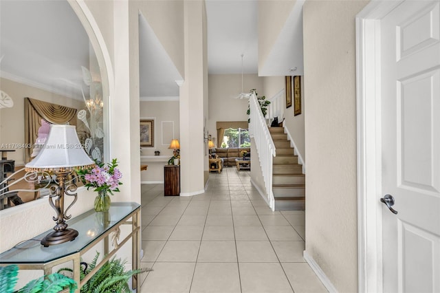 11919 NW 47th St, Coral Springs, FL 33076 - entrance foyer with crown molding, light tile patterned floors, stairs, arched walkways, and baseboards